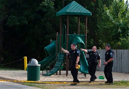 In this Aug. 4, 2014 photo, Kentwood police investigate a stabbing that occurred in a playground in Pinebrook Village, in Kentwood, Mich. Police said a 12-year-old boy has stabbed a 9-year-old boy at the playground in western Michigan, sending the child to a hospital. Police also didn't immediately release detail on the condition of the wounded child. The older boy was taken into custody for questioning by police. (AP Photo/The Grand Rapids Press, Joel Bissell)