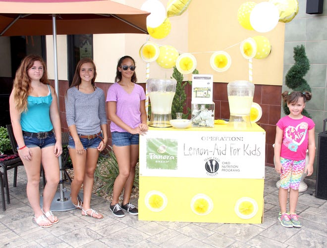 Volunteering for duty Friday at the Lemon-Aid for Kids stand in Palm Coast were, from left, Marietta Romaine, 14, Lily Alford, 14, Cassandra Hunter, 13, and Phoebe Kitchens, 8. Funds raised from the two-day effort will benefit Team Feed Flagler.