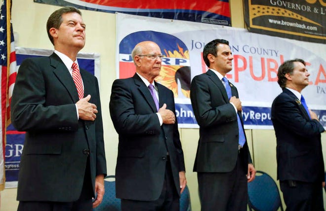Gov. Sam Brownback, left, Sen. Pat Roberts, Rep. Kevin Yoder and Lt. Gov. Jeff Colyer, right, pledge allegiance Tuesday at the Republican gathering in the Overland Park Marriott Hotel.