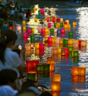KYODO NEWS/AP / Paper lanterns float along the Motoyasu River in front of the Atomic Bomb Dome in Hiroshima, Japan, on Wednesday. Japan marked the 69th anniversary Wednesday of the atomic bombing of Hiroshima. 
 KYODO NEWS/AP / People pray for the atomic bomb victims in a rain at the Hiroshima Peace Memorial Park in Hiroshima, Japan, early Wednesday. Japan marked the 69th anniversary Wednesday of the atomic bombing of Hiroshima.