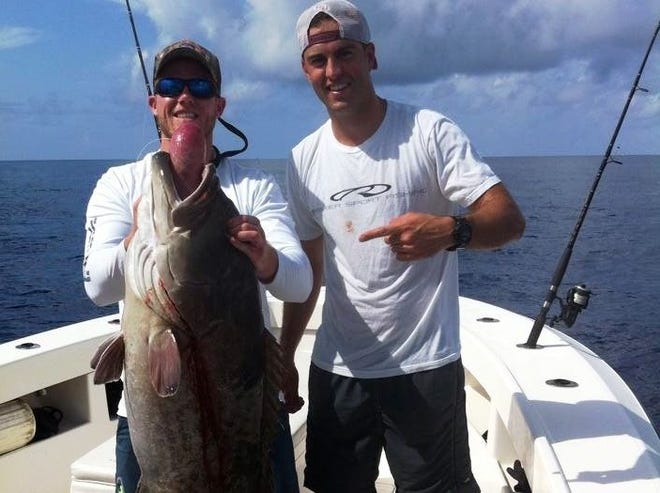 James Fleenor, left, holds a 40-pound grouper he caught on a recent offshore outing. Fleenor's friend Ricky Whitson is also pictured.