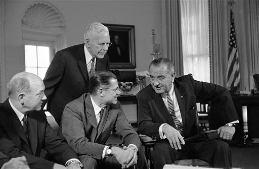 In this March 13, 1964 file photo, President Lyndon Johnson, right, talks with Secretary of Defense Robert McNamara, center sitting, after McNamara returned from a fact-finding trip to South Vietnam, at the White House in Washington. Fifty years ago Sunday, Aug. 10, 2014, reacting to reports of a U.S. Navy encounter with enemy warships in the Gulf of Tonkin off Vietnam, reports long since discredited, Johnson signed a resolution passed overwhelmingly by Congress that historians call the crucial catalyst for deep American involvement in the Vietnam War. (AP Photo/File