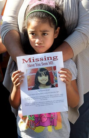 Moana Tuitasi,6, holds up a flyer of her missing classmate Jenise Wright at a law enforcement news conference on Tuesday, Aug. 5, 2014 in Bremerton, Wash. She came with her mom Ruby to show support for the search. Jenise was last seen Saturday night at her home in the Steele Creek mobile home park. Her family reported her missing Sunday night. Wilson said the parents took an FBI lie-detector test and are cooperating. (AP Photo/Kitsap Sun, Larry Steagall)