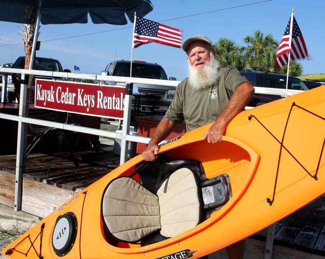 Tom Leibert rents kayaks from his Kayak Cedar Key booth adjacent to the public beach.