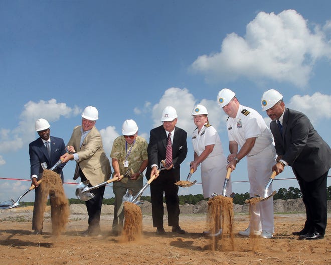Dignitaries ceremonially break ground on two new military clinics on Magnolia Beach Road in Panama City Beach on Thursday.