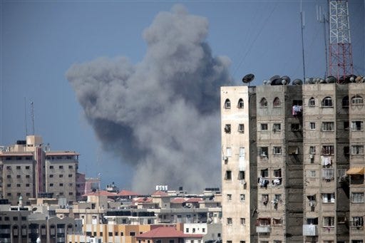 Smoke rises over Gaza City after an Israeli strike, Friday, Aug. 8, 2014, as Israel and Gaza militants resumed cross-border attacks after a three-day truce expired and Egyptian-brokered talks on a new border deal for blockaded Gaza hit a deadlock. (AP Photo/Khalil Hamra)