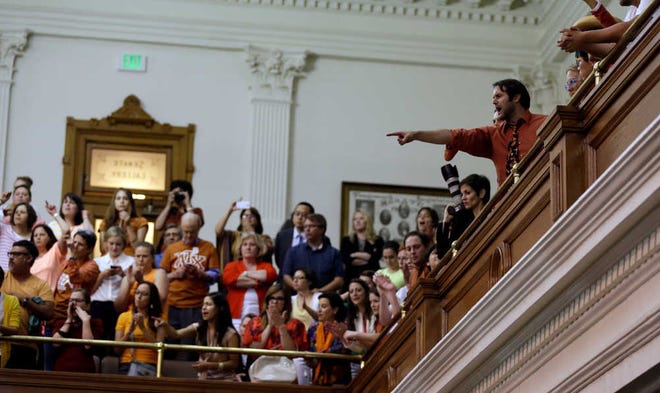FILE - In this June 26, 2013 file photo, members of the gallery cheer and chant as the Texas Senate tries to bring an abortion bill to a vote as time expires in Austin, Texas. In Texas, abortion providers were in court in the first week of August 2014 asking a federal judge to stop a new law that they say would close more than half of the state's abortion facilities by imposing costly new standards. (AP Photo/Eric Gay, File)