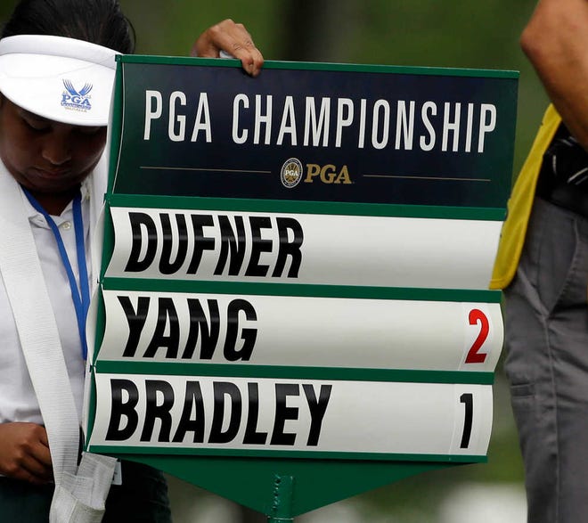 Jason Dufner's scorch is taken off the scoreboard after he withdraw after playing 10 holes during the first round of the PGA Championship golf tournament at Valhalla Golf Club on Thursday, Aug. 7, 2014, in Louisville, Ky. (AP Photo/John Locher)