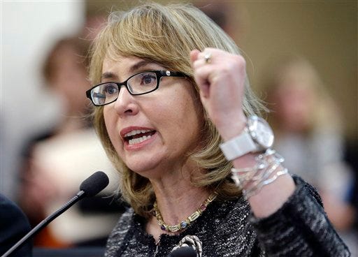 This Jan. 28, 2014 file photo shows former Arizona Congresswoman Gabrielle Giffords testifying before a Washington state House panel considering an initiative to expand firearm background checks, in Olympia, Wash. Giffords, who survived a 2011 shooting, is set to visit Maine Saturday, Aug. 9, 2014, to help raise money for Democrat gubernatorial hopeful Mike Michaud.