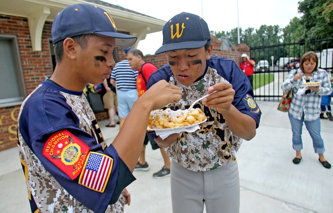 Members of the Hawaii team sample some of the food at Keeter Stadium in 2013. STAR FILE PHOTO