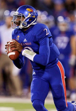 Kansas Jayhawks quarterback Montell Cozart looks to pass in the first quarter of an NCAA college football game against the Baylor Bears, Saturday, Oct. 26, 2013, in Lawrence, Kan.