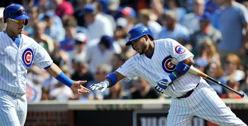 Chicago Cubs' Javier Baez left, celebrates with teammate Luis Valbuena right, after Baez scored on a Starlin Castro single during the first inning of a baseball game against the Tampa Bay Rays in Chicago, Friday, Aug. 8, 2014. (AP Photo/Paul Beaty)