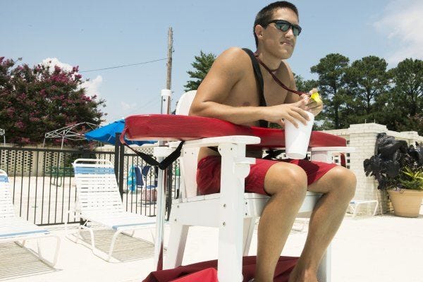Lifeguard Tyler Bennett watches swimmers in the pool at Highland Country Club. The club employees many high school and college students during the summer.