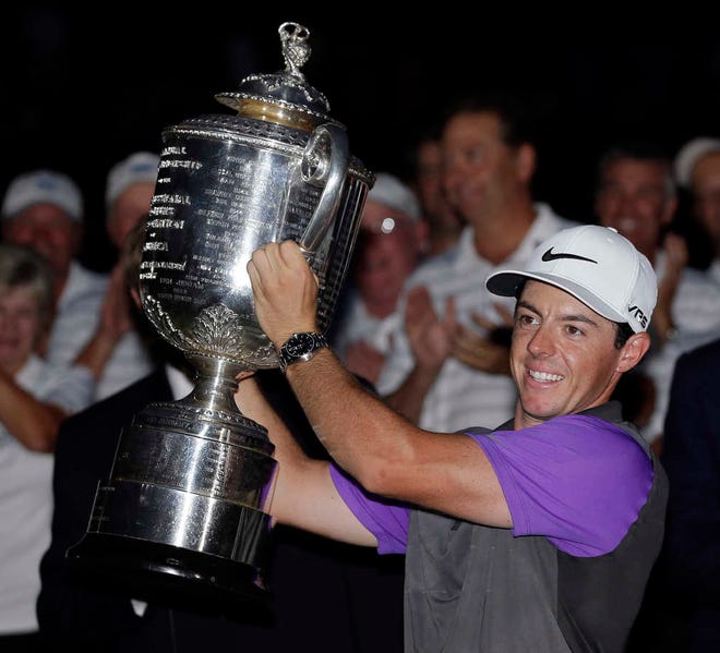 Rory McIlroy, of Northern Ireland, holds up the Wanamaker Trophy after winning the PGA Championship golf tournament at Valhalla Golf Club on Sunday, Aug. 10, 2014, in Louisville, Ky. (AP Photo/David J. Phillip)