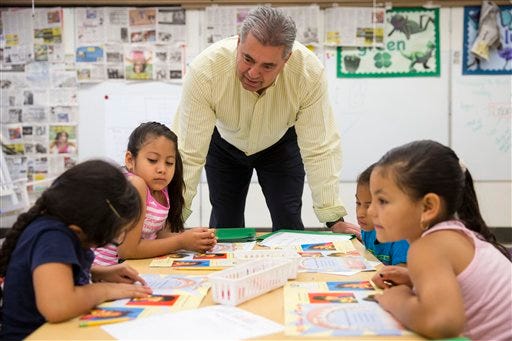 This photo taken July 21, 2014 shows Kennett Consolidated School District Superintendent Barry Tomasetti meeting with young students in teacher Jane Cornell's summer school class at Mary D. Lang Kindergarten Center in Kennett Square, Pa. For the first time ever _ U.S. public schools are projected this fall to have more minority students enrolled than white, a shift largely fueled by growth in the numbers of Hispanic children. White students are still expected to be the largest racial group in the public schools this year at 49.8 percent, but according to the National Center for Education Statistics, minority students, when added together, will now make up the majority.
