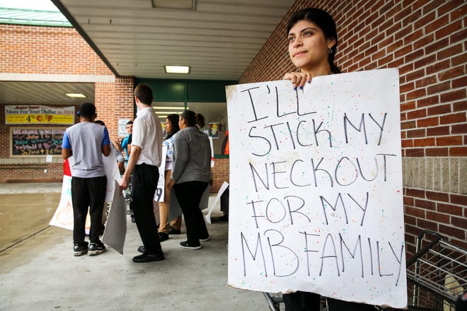 Erica Mendoza, of Framingham, shows her support for Arthur T. Demoulas outside Market Basket in Ashland last week. DAILY NEWS PHOTO BY DAN HOLMES