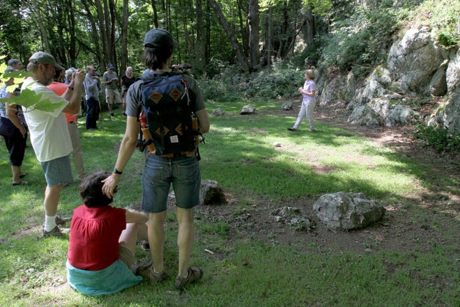 Jennifer Bristol, executive director of Mount Hope Farm, shows a group of visitors King Philip's seat, a sacred Native American site, Friday in Bristol.