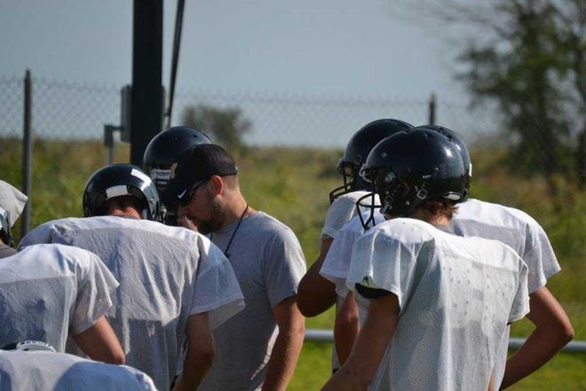 McLean coach Kade Kittley meets with his players during practice Monday morning.