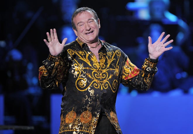 This April 6, 2008 file photo shows actor-comedian Robin Williams speaks on stage at the "Idol Gives Back" fundraising special of "American Idol" in Los Angeles. Williams, whose free-form comedy and adept impressions dazzled audiences for decades, has died in an apparent suicide. He was 63. The Marin County Sheriff's Office said Williams was pronounced dead at his home in California on Monday, Aug. 11, 2014.