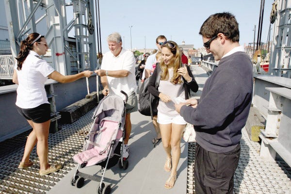 Passengers board the Seastreak from State Pier for the 9:30 a.m. Friday departure to Martha's Vineyard. The ship was sold out for this trip.