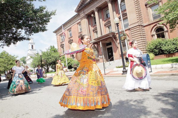 Senoritas walk by City Hall on Sunday morning during the Latino Beach Cultural Festival Parade in New Bedford. The parade was one of the culminating events of the festival organized by the Puerto Rican and Latin American Art and Culture Committee.