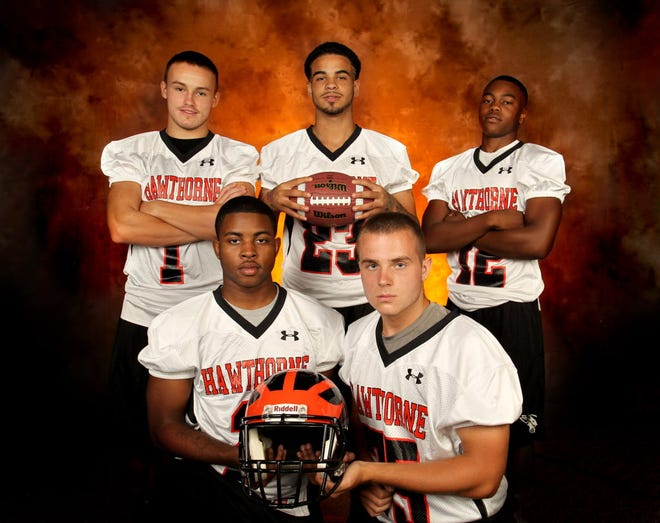Hawthorne players left to right, Austn Brown (1) running back, Dionte Mann (23) linebacker, Latrevious Mann (12) wide receiver with bottom left to right, Torres Williams (2) quarterback and Nicholas Herring (75) offensive lineman during High School Media Days at the Gainesville Sun July 29, 2014.