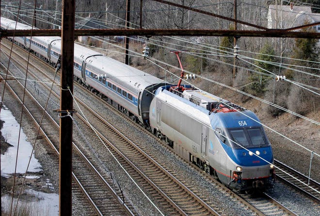 FILE - In this Jan. 5, 2010, file photo, a northbound Amtrak Acela passes through Middle River, Md. The Drug Enforcement Administration paid an Amtrak secretary $854,460 over nearly 20 years to obtain confidential information about train passengers, which the DEA could have lawfully obtained for free through a law enforcement network, The Associated Press has learned. (AP Photo/Rob Carr, File)
