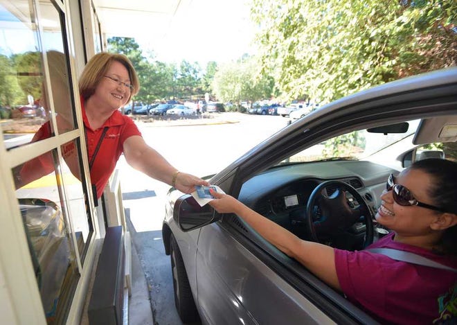 Wendy Glenn talks with a customer in the East Campus Parking Deck on Wednesday, Aug. 13, 2014, in Athens, Ga.  (Richard Hamm/Staff) OnlineAthens / Athens Banner-Herald