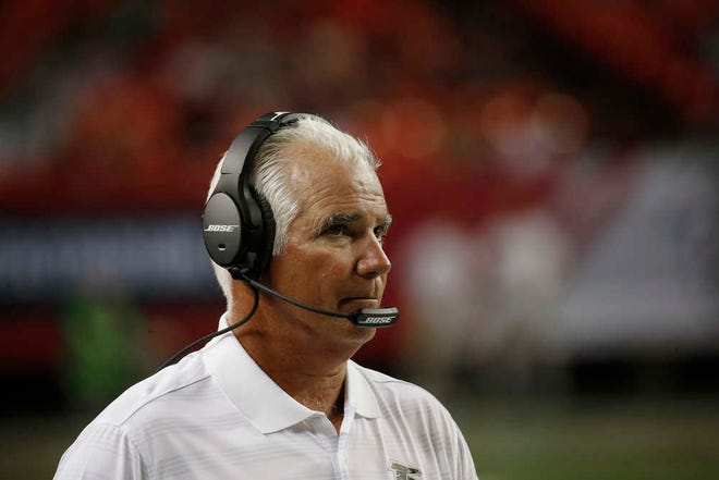 Atlanta Falcons head coach Mike Smith watches play against the Miami Dolphins during the second half of an NFL preseason football game, Friday, Aug. 8, 2014, in Atlanta. (AP Photo/John Bazemore)