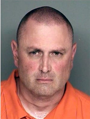 This undated booking photo provided by the Santa Barbara County Sheriff's Office shows Nicolas Holzer. Holzer, 45, told authorities he stabbed his parents, his two young sons and the family dog to death in their home because he believed it was his destiny, authorities said Tuesday, Aug. 12, 2014. Sheriff's deputies found the bodies of Nicolas Holzer's mother and father, and his sons, ages 10 and 13, in the home near the University of California, Santa Barbara, late Monday. They were summoned by Holzer, who told a police dispatcher in a calm, matter-of-fact voice that he had killed his relatives, authorities said. (AP Photo/Santa Barbara County Sheriff's Office)
