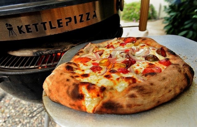 An attachment for a Weber grill called the KettlePizza makes a very good approximation of a wood-fired pizza on a reasonable budget. (Wally Skalij/Los Angeles Times/MCT) 
 An attachment for a Weber grill called the KettlePizza makes a very good approximation of a wood-fired pizza on a reasonable budget. (Wally Skalij/Los Angeles Times/MCT)