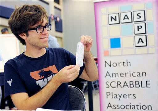 Conrad Bassett-Bouchard poses with his scorecard after he won the title at the National Scrabble Championships, Wednesday, Aug. 13, 2014, in Buffalo, N.Y. (AP Photo/Gary Wiepert)