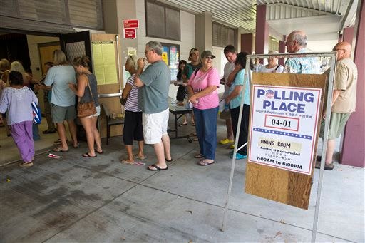 Voters crowd the cafeteria of the polling place held at Keonepoko Elementary School, Friday, Aug. 15, 2014, in Pahoa, Hawaii. Many voters were waiting over an hour to cast their vote today. A steady flow of residents recovering from Tropical Storm Iselle began casting votes Friday to finally decide who wins Hawaii's Democratic U.S. Senate primary - a race expected to determine who will serve the final two years of the late U.S. Sen. Daniel Inouye's term in the strongly Democratic state. (AP Photo/Marco Garcia)