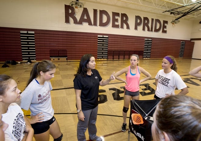 First-year Navarre coach Amy Walls talks to her team during Friday's practice.