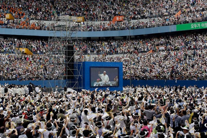 Pope Francis is seen on a huge screen upon Pope's arrival for the Mass of Assumption of Mary at Daejeon World Cup stadium in Daejeon, south of Seoul, South Korea, Friday, Aug. 15, 2014.