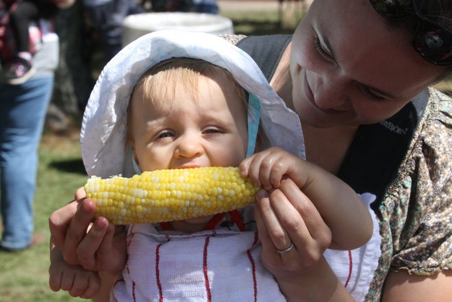 Clare Schon, top, gets her first taste of corn on the cob — with help from her mother, Katie Schon, at the 48th annual Washington County Fair. Katie, who grew up in North Kingstown but now lives in Texas, was in Rhode Island to visit family.