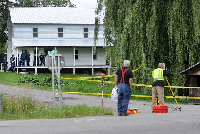 With community members watching from the background, New York State Police crime scene investigators work the scene of an abduction near a roadside vegetable stand in Oswegatchie, N.Y., Thursday, Aug. 14, 2014. They were searching for clues in the disappearance of sisters, Delila, 6 and Fannie Miller, 12, who were reported taken from the stand around 7:30 on Wednesday evening. (AP Photo/Watertown Daily Times, Melanie Kimber-Lago)