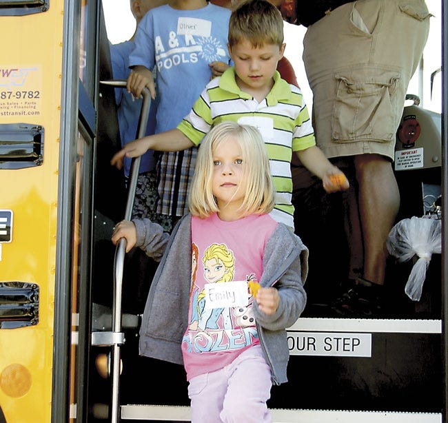 Michelle Patrick/Journal
Emily Stone and Grant Happel make their way safely off a school bus Wednesday during a camp exercise at Safety Town in Sturgis. The two-week long camp covers various safety topics.