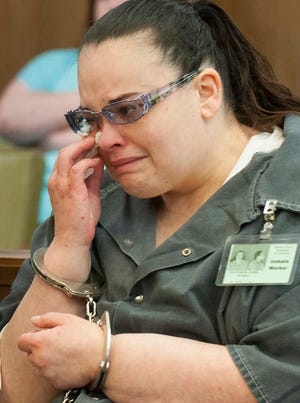 Jamie Engstrom, 36, wipes away tears during her sentencing Friday morning. Engstrom pleaded no contest to charges of conspiracy to commit second degree murder, aggravated battery and aggravated child endangerment and was sentenced to a total of 14 years and one month.