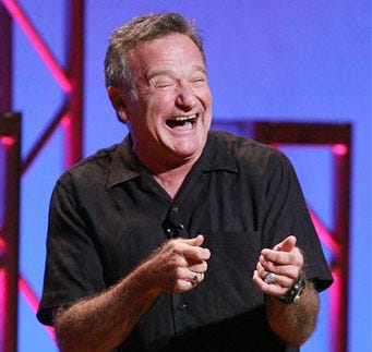 This Nov. 23, 2009 photo released by Starpix shows actor-comedian Robin Williams performing his stand-up show, “Weapons of Self Destruction,” at Town Hall in New York. Williams' wife Susan Schneider released a statement Thursday, Aug. 14, 2014 announcing that Williams had early stages of Parkinson's disease. He died Monday of an apparent suicide at the age of 63. (AP Photo/Starpix, Dave Allocca)