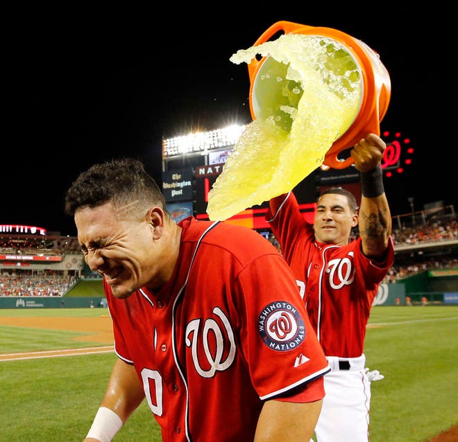 Washington Nationals' Wilson Ramos, front, gets dunked by Ian Desmond after Ramos hit a game-winning, RBI double in the ninth inning to beat the Pittsburgh Pirates, 4-3, at Nationals Park in Washington.