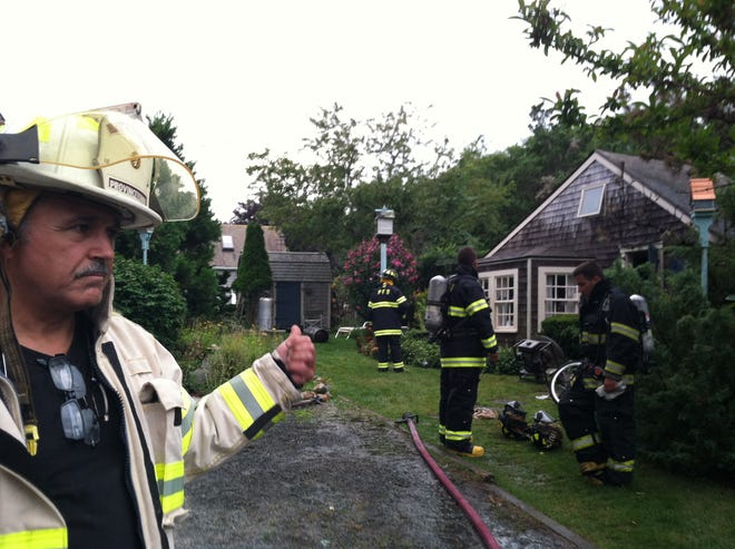 Provincetown Fire Chief Mike Trovato in front of the burned cottage at 60 Commercial St. in Provincetown.