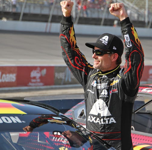 NASCAR Sprint Cup Series driver Jeff Gordon celebrates Friday after winning the pole for the Pure Michigan 400.