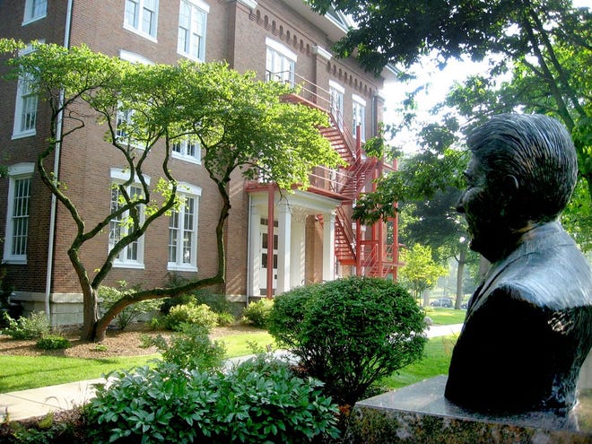 With a bust of Eureka College alum Ronald Reagan in the foreground, Eureka's oldest building, Burrus Dickinson Hall, built in 1858, stands in the background. Despite pressures from a decline in high school graduates and rising college costs, Eureka welcomes the second-largest freshman class in the school's 160-year history this fall.