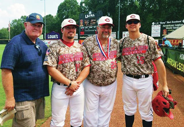 A representative of the American Legion World Series presents Columbia Post 19 coach Holden Killen, team manager Mickey McKeel and head coach Scott Beasley with their World Series medals. (Courtesy photo)
