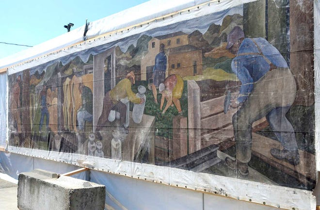 This Aug. 8, 2014 photo shows a large mural displayed at the Skagit County Fair in Mount Vernon, Wash. Its origin once a mystery, a Seattle art dealer confirmed on Friday, Aug. 15, 2014 that the canvas is an original 1941 painting by William Cumming. (AP Photo/The Skagit Valley Herald, Scott Terrell)