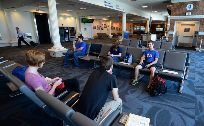 In this June 18, 2014 photo, passengers wait on a flight at Montgomery Regional Airport in Montgomery, Ala. (AP Photo/Montgomery Advertiser, Mickey Welsh)