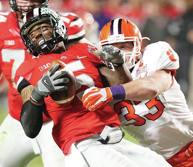 Ohio State quarterback Braxton Miller is sacked by Clemson's Spencer Shuey (33) in the second quarter in the Discover Orange Bowl at Sun Life Stadium in Miami Gardens, Fla., on Jan. 3. (Al Diaz/MCT)