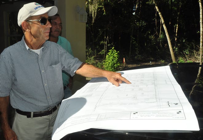 Arthur Kowitz looks over plans for a 11-home neighborhood called The Canopy that he is creating in Ormond Beach. The 20-acre development site is along Arroyo Parkway, just east of South Nova Road.