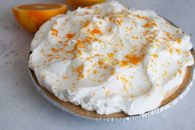 This July 21, 2014 photo shows orange-vanilla ice cream pie with orange whipped cream in Concord, N.H. The dish offers the creamy-sweet richness of a Creamsicle. (AP Photo/Matthew Mead)